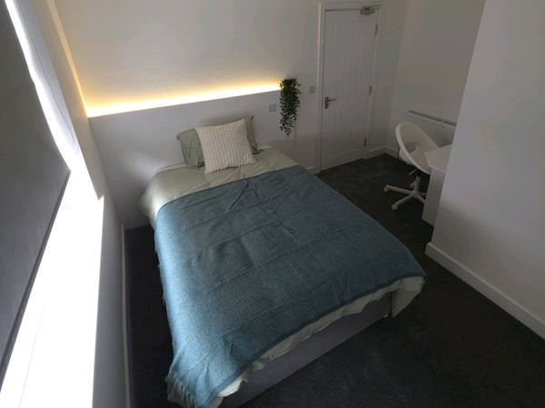 A furnished room at 23 Kilwick Street, Hartlepool, with a study desk and sloped ceiling