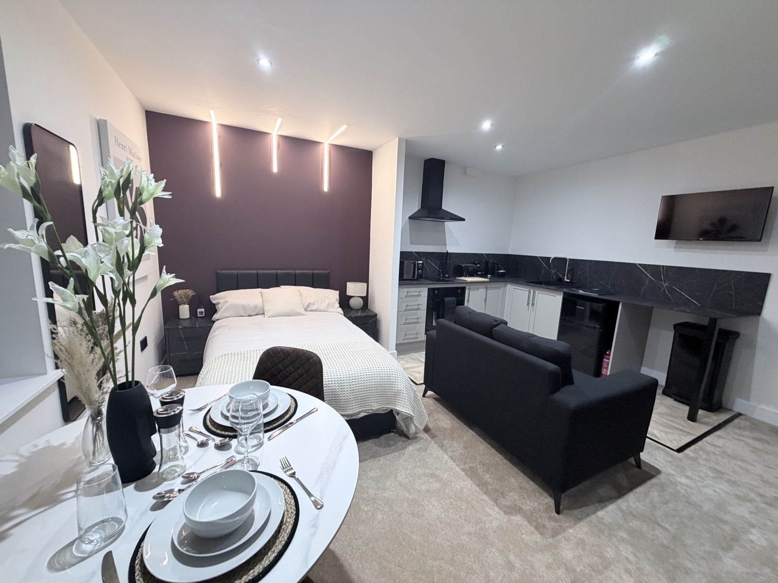 A stylish studio apartment we manage, with feature lighting, a modern kitchen and lounge area
